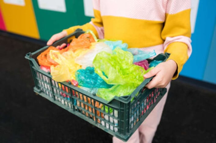 Woman carrying plastic wraps