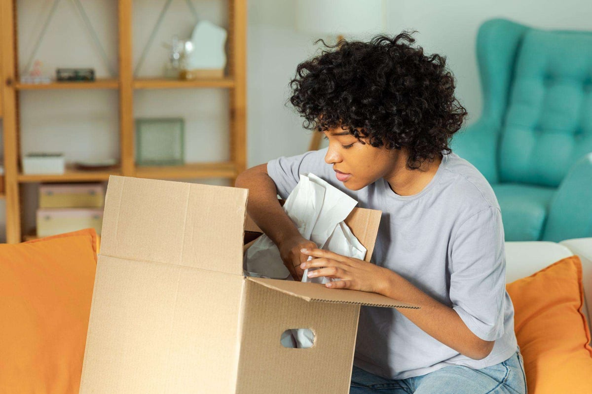 black woman opening a box